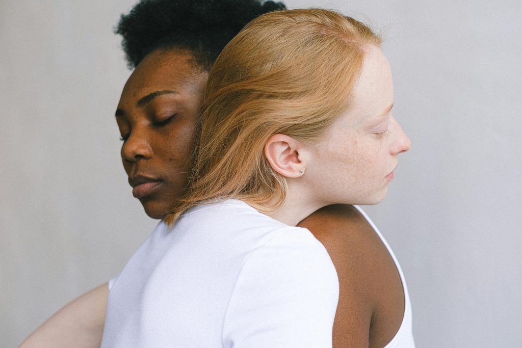 Tender embrace between an interracial couple showcasing love and connection.